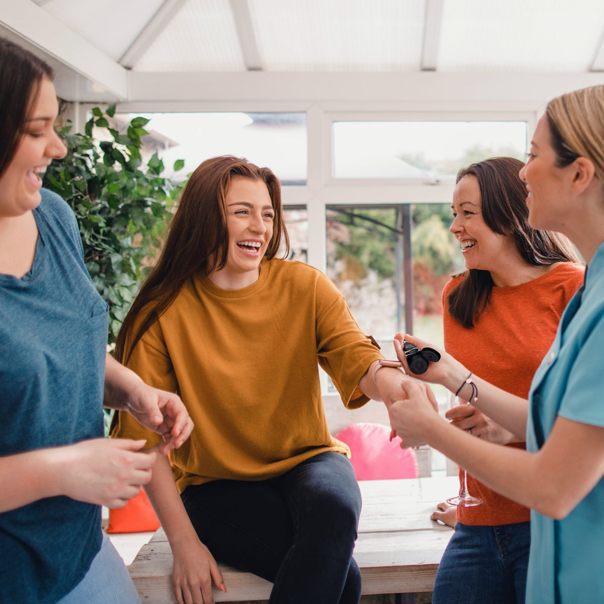 Fröhliche Frauen mit HAKA Care + Repair Creme bei einer HAKA Party