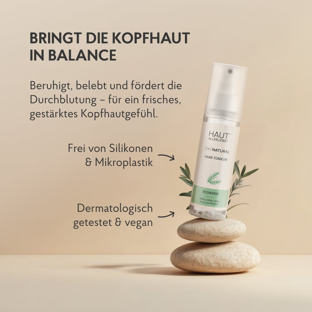 Haartonikum balanciert auf Steinen, dahinter Rosmarin